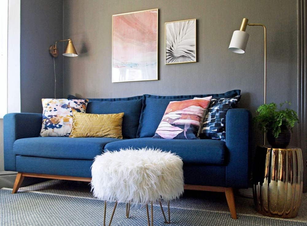 Navy blue sofa with grey wall