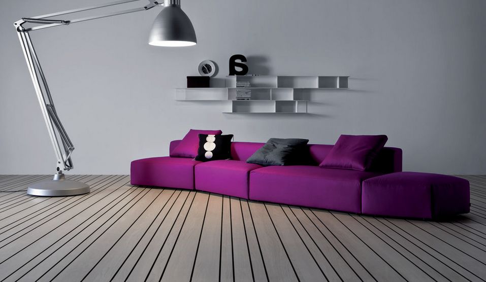 purple color sofa with grey wall